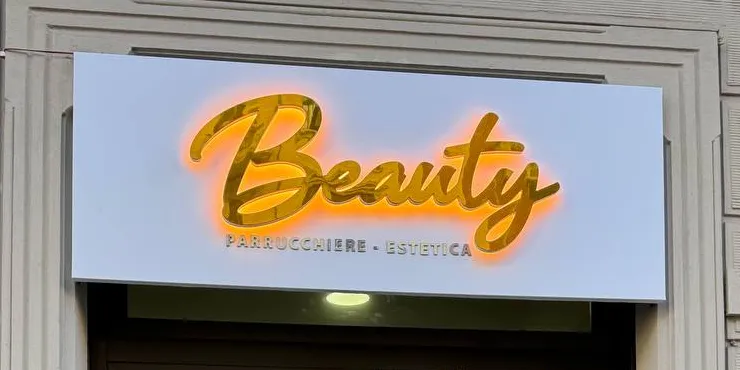 Insegna Beauty con scritta oro specchiata e retroilluminazione calda